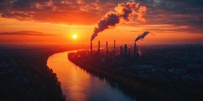 A factory with smoke coming out of the chimneys at sunset photo