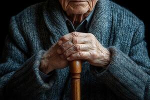 An old man with a cane in his hand photo
