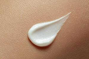 A white cream is being applied to a woman's skin photo