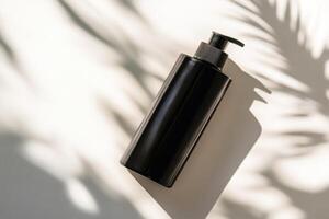 A black bottle of lotion on a white surface photo