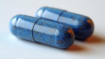Unique blue capsules on a smooth surface highlighting their glossy texture and intricate speckles photo