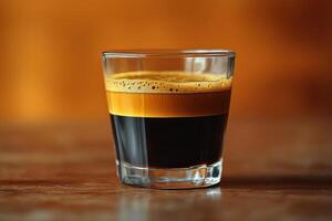 An espresso drink with a black liquid in it photo