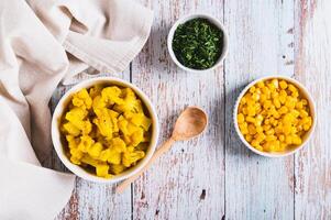 Vegetarian curry with potatoes and cauliflower in a bowl on the table top view photo