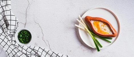 Sausage filled with fried egg and garlic on a plate on a table top view web banner photo