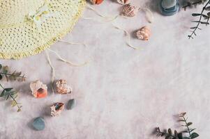 Travel background, hat, shells, stones and branches top view photo