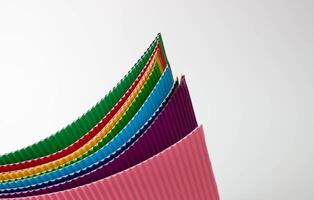 A roll of multicolored sheets of corrugated paper. photo