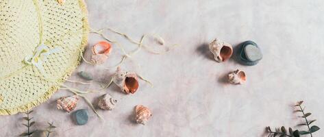 Travel background, hat, shells, stones and branches top view web banner photo