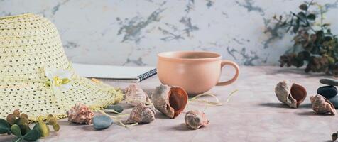 Travel background, hat, shells, stones and cup of coffee on table web banner photo