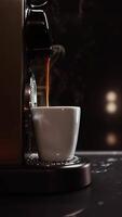 Close-up of espresso machine brewing coffee, with fresh coffee dripping from spouts. Highlighting process of making aromatic espresso. Vertical footage. Dark background video