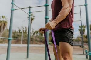 Close up of the hands of a man training with resistance photo