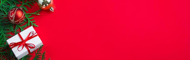 Christmas and new year concept. Gift boxes and decor on red background. photo