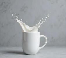 Milk Splashing Out of a White Mug on a Gray Surface photo