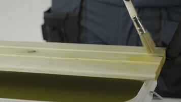 A tutorial shows treating wood with a yellow liquid, ensuring even coverage. Creative photo