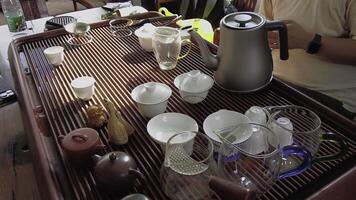 A beautiful traditional tea set display featuring various cups and teapots for tea time enjoyment. Media photo