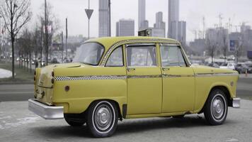 Classic yellow checker cab rotating on display. Action photo