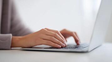 Hands typing on a laptop keyboard in a bright workspace, showcasing productivity and focus, ideal for remote work and digital communication, technology concept photo