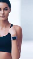 Fitness enthusiast wearing a smartwatch in a modern gym environment showcasing health and technology integration for a healthy lifestyle concept photo