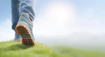 Walking on green grass with hiking boots, enjoying nature and fresh air, exploring the outdoors, healthy lifestyle concept photo