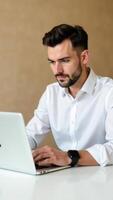 Professional man working on laptop in modern office setting, focused on task at hand, showcasing productivity and concentration, remote work concept photo