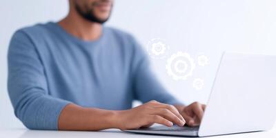 Focused man working on laptop with gears symbolizing technology and innovation in a modern workspace environment digital transformation concept photo