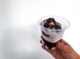 Choco Vanilla Sundae Ice Cream in Plastic Cup Isolated on White Background photo
