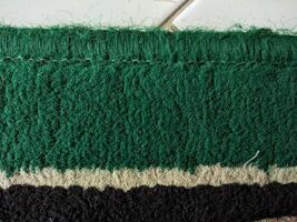 rough texture forming abstract motif. combination of green, cream, and black photo