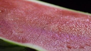 Pulp of watermelon gyrating on black background video