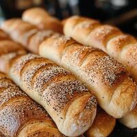 Closeup of Seeded Crusty Baguettes Stacked, Golden Brown Fresh Baked Bread Loaves photo
