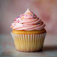 Cupcake with Pink Frosting and Colorful Sprinkles on a Blurred Pastel Backdrop photo