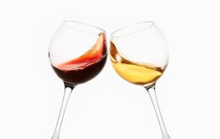 Glasses of red, white wine clink during toast. photo