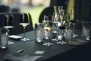 Layout of wine glasses on the table, preparing for the tasting of alcoholic beverages. Preparation to blind wine degustation for beginners sommelier. Wine school, winemaking lecture. photo