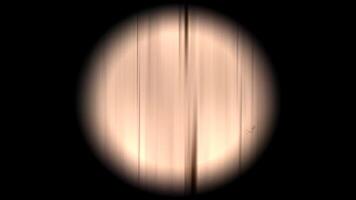 A circular light is shown in the dark video