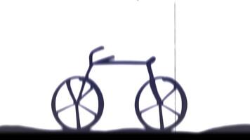 A shadow of a bicycle is shown on a white background video