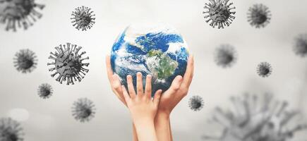 Hands holding the earth with corona virus around it photo