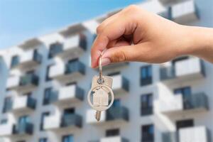 A person holding a key to a building photo