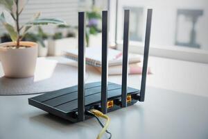 A router with three antennas on a table photo