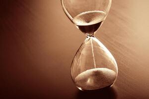 A sand timer on a table photo