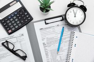 Tax income concept with calculator and pen on desk photo