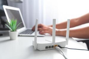 A person is using a router on a desk photo