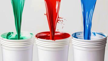 Bold colors of paint pour out, filling up the containers below photo