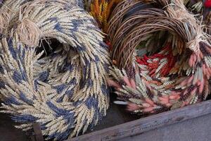 Brightly crafted spring wreaths featuring spikelets, lavender flowers and festive Easter decorations are displayed at a local market. These unique creations add charm to Easter celebrations. photo