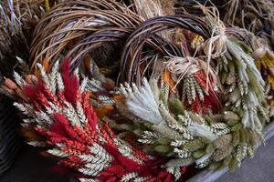 Colorful spring wreaths designed with spikelets and ears of wheat create a festive atmosphere for Easter celebrations. These decorations embody the essence of spring with their natural textures. photo