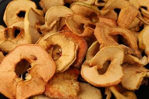 Dried apple slices arranged neatly for healthy snacking or cooking use during autumn harvest season photo