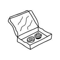 Hand drawn doodle open cardboard box with a donut and cupcake inside. Isolated on white background vector