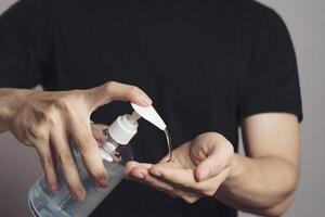 Man washing hands with alcohol gel or antibacterial soap sanitizer.Hygiene concept. prevent the spread of germs and bacteria and avoid infections corona virus at home. photo