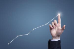 Success businessman with business growing graph growing virtual hologram of statistics, graph with arrow up on blue background. Stock market. Business growth, planing and strategy concept. photo