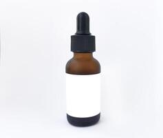 Brown dropper bottle with blank label and pipette isolated on white background, perfect for mockups and advertising of skin care products, essential oils, medicines or cosmetics photo