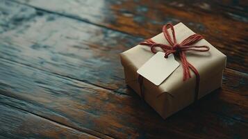 Gift box with tag on wooden table photo