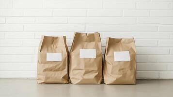 Three brown paper bags with white paper on them photo