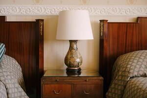 Cozy Bedroom Setting with Elegant Lamp and Bedside Table photo